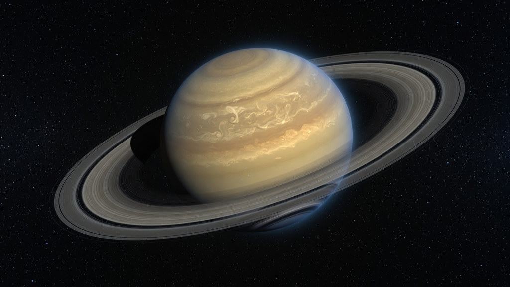 Saturn with its ring system against a starry black space background